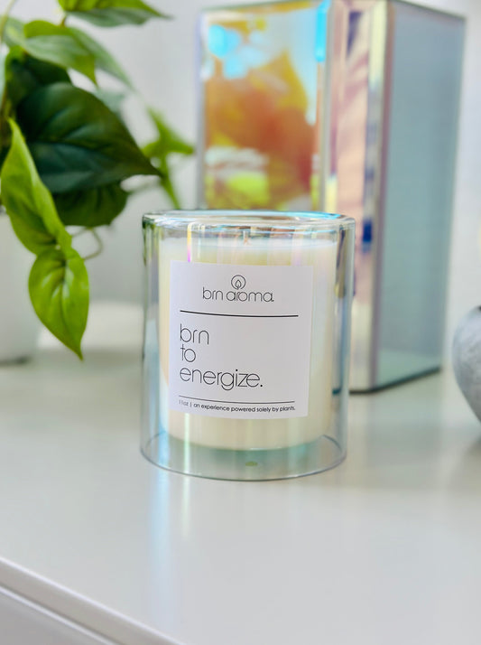 burn to energize aromatherapy candle in an iridescent glass double wall vessel.